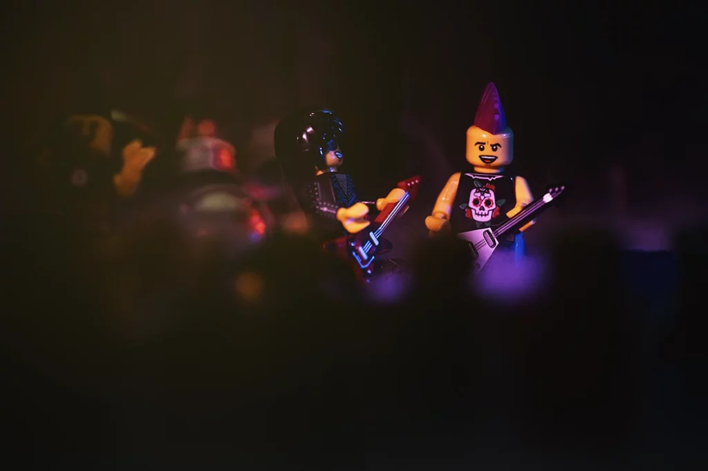 Legography sur le thème d'un concert de musique Metal. Cette photographie représente les guitaristesr du groupe en plein action.